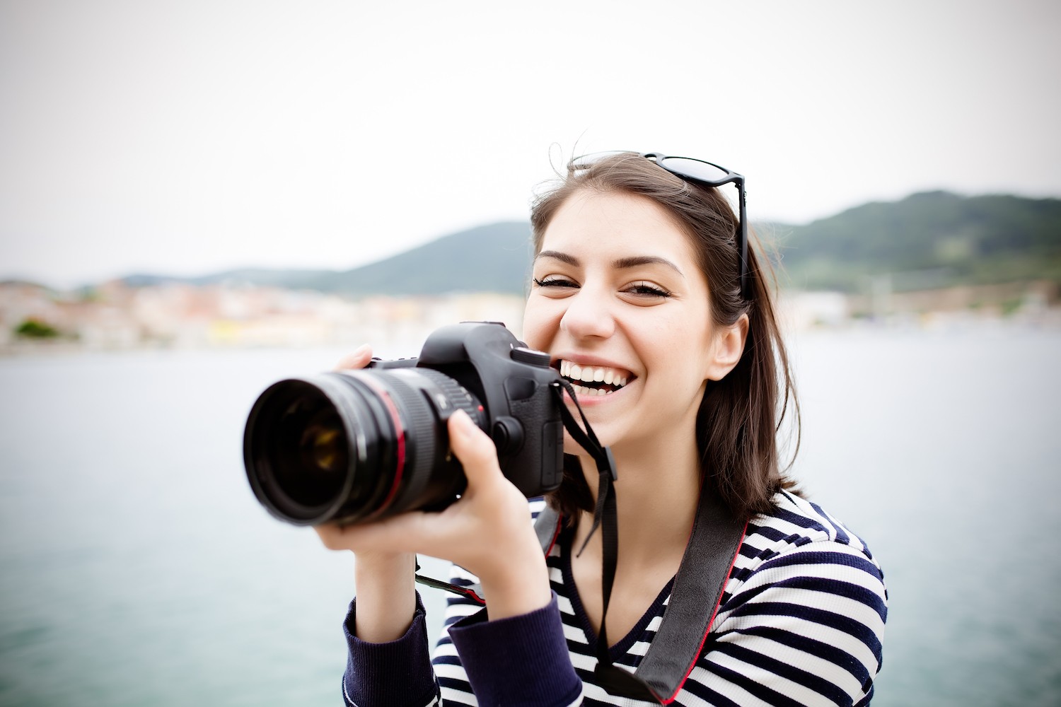 Mature woman using a camera to take photo outdoors